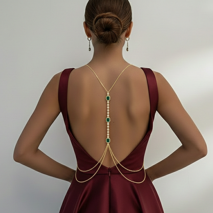 Green stone body chain worn with a deep-back saree