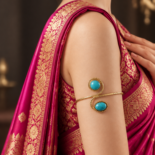 Twin turquoise spiral arm cuff worn on the upper arm