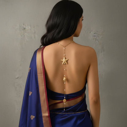 Coastal charm back chain worn over a backless swimsuit