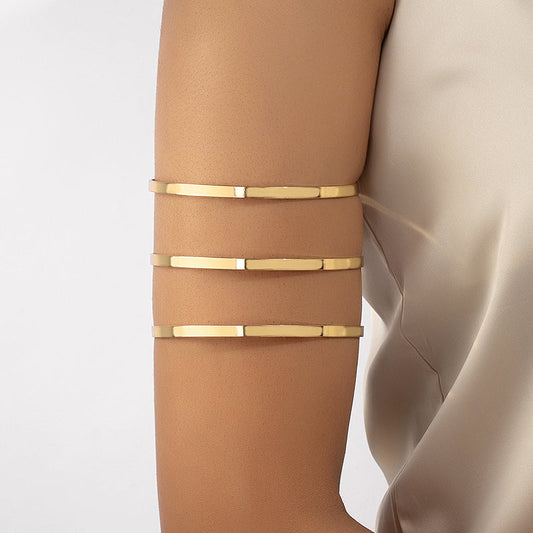 Tri-Gleam arm cuff with three tiers in gold-tone
