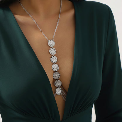 Medallion body chain worn with a deep-plunge neckline