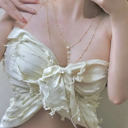 Layered pearl body chain worn with a corset top, 60 gms