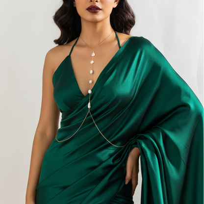 Pearl cascade body chain worn with a deep neckline