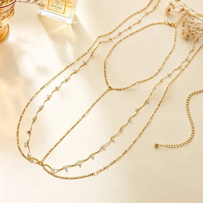 Layered tassel body chain in gold-tone